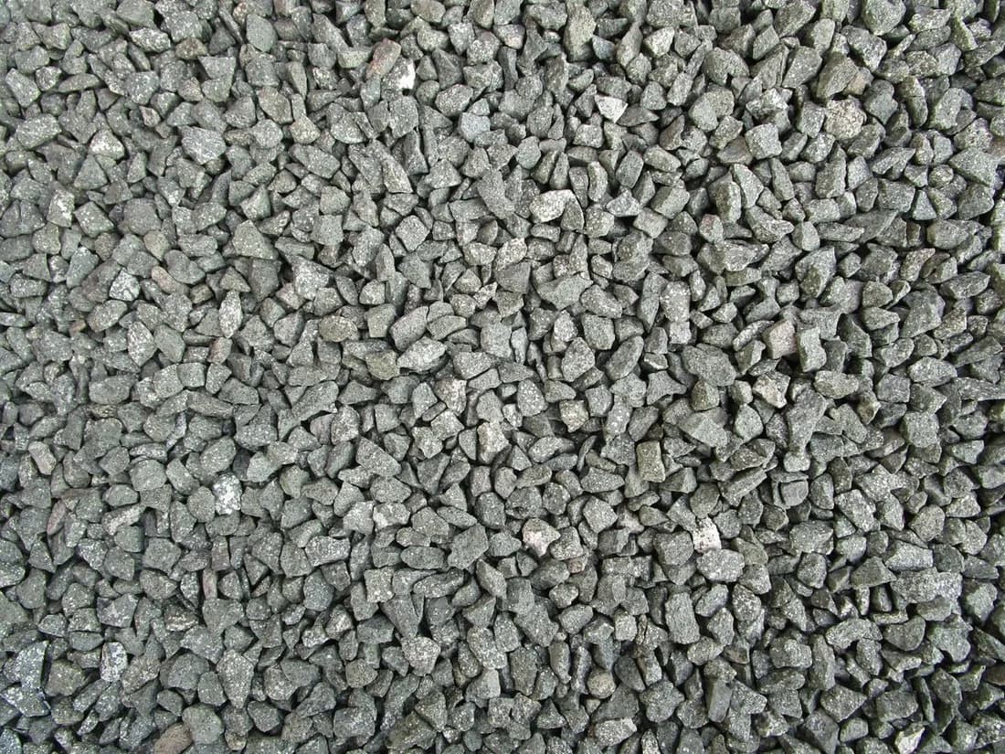 Close-up photograph of coarse gray crushed stone with varied natural texture