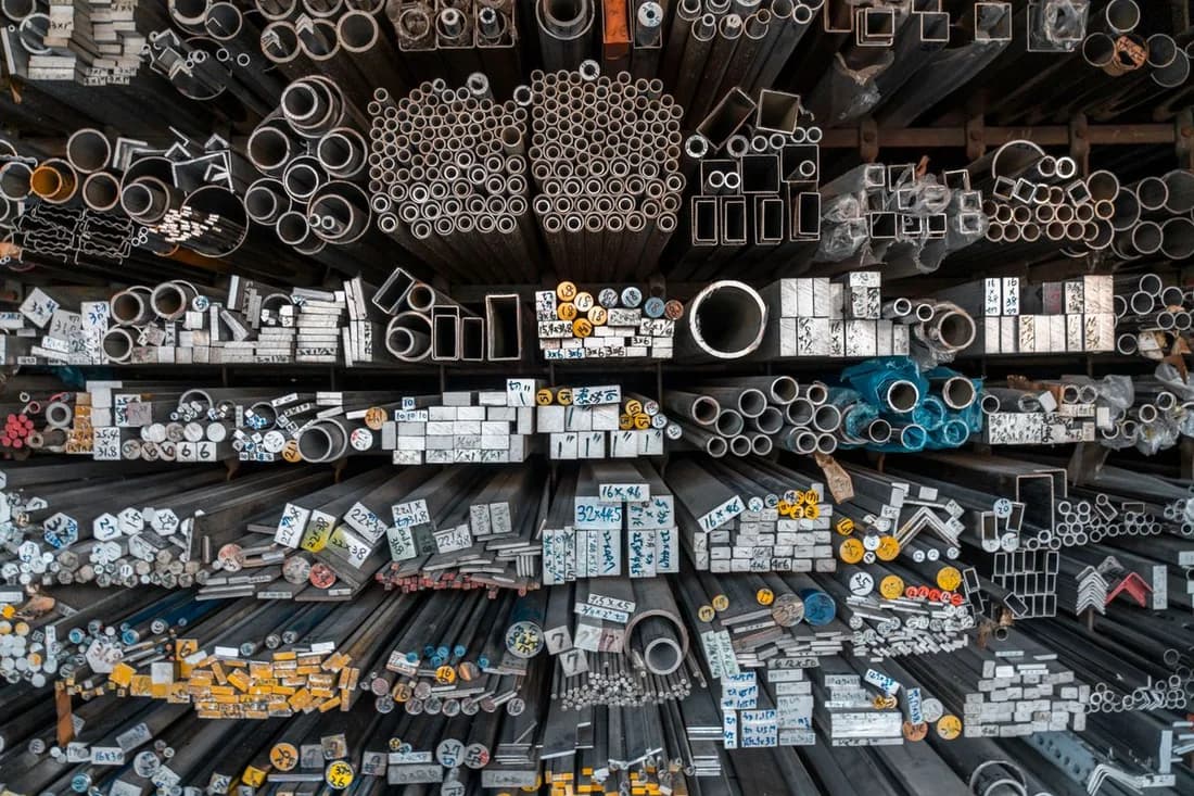 Assorted metal bars and tubular sections arranged in a material display